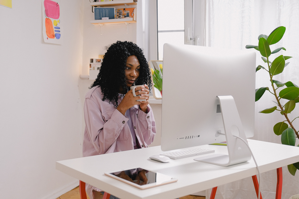 Young black woman freelancing with computer at home